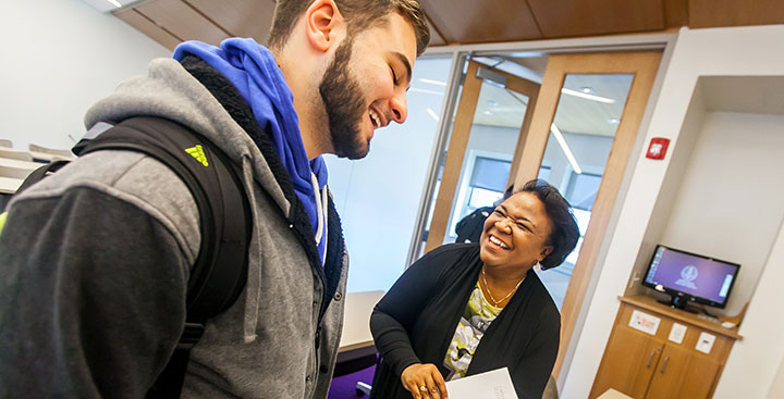 Curry College student and faculty interact in class