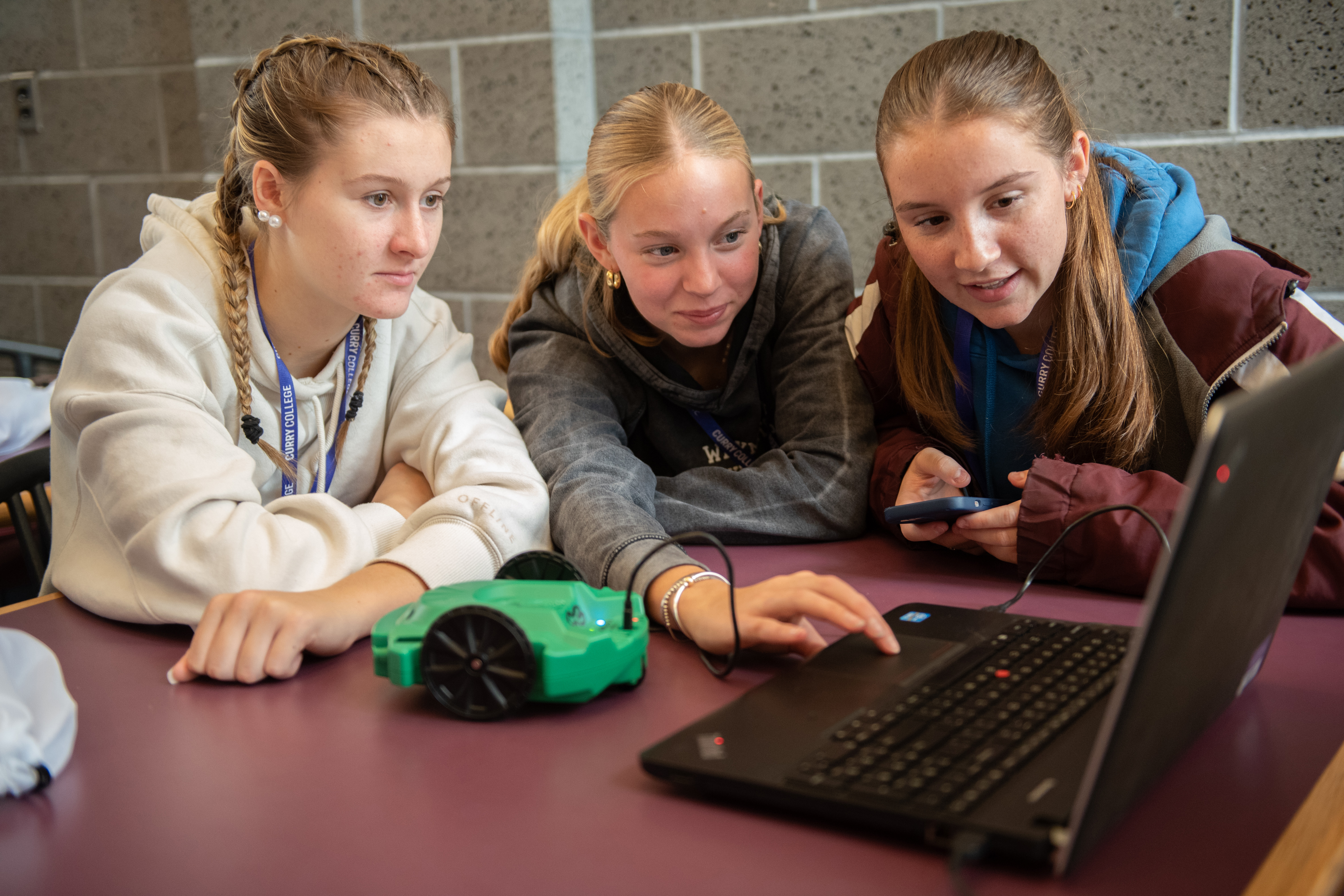 Students studying coding on a laptop at tech conference