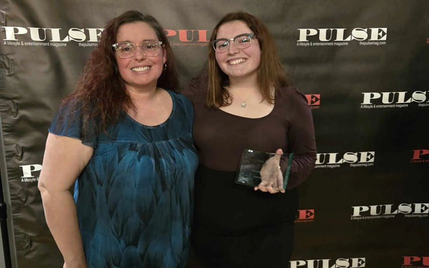 Helena poses with award