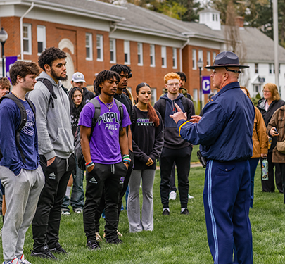 A Massachusetts State Police officer speaks to a Curry Criminology and Criminal Justice class