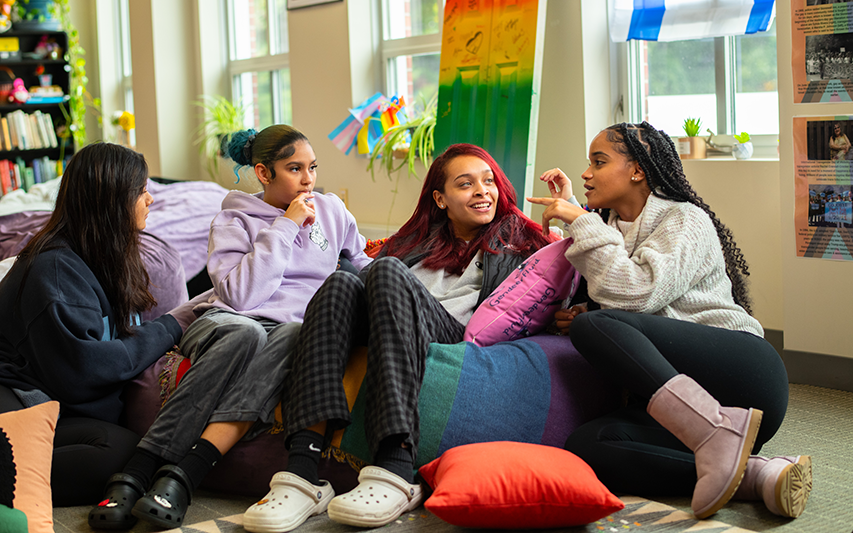 Students in the Curry College Diversity Center chat on the beanbag chairs