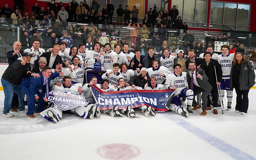 men's hockey poses with CNE championship trophy and banner 