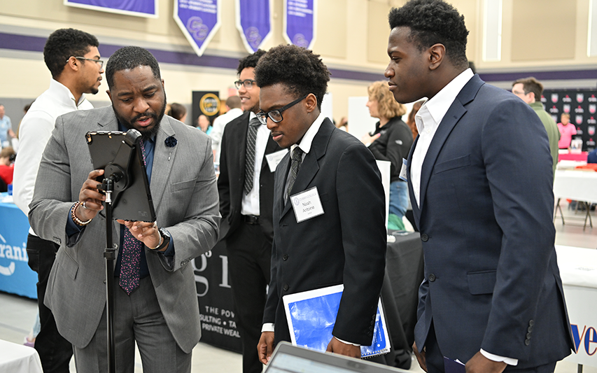 Students talk with an employer partner at Career Fair