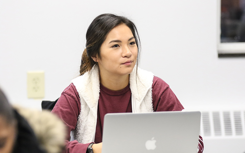 A student in class on her laptop