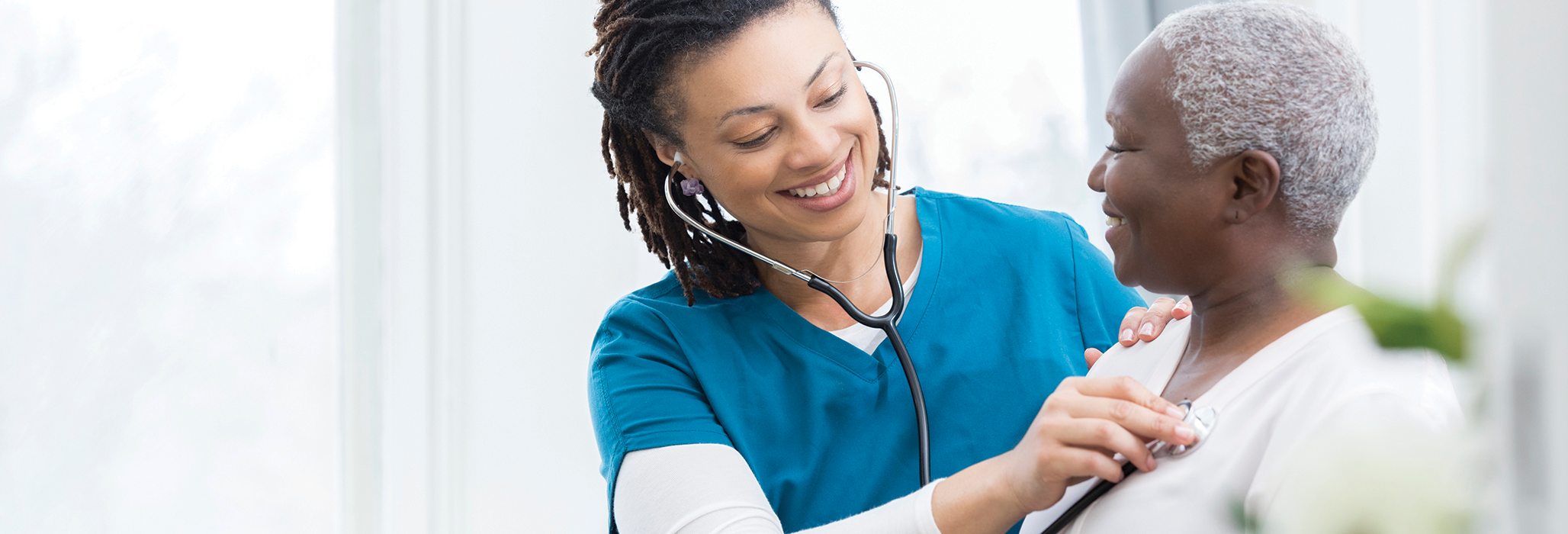 A nurse checks breath sounds of her patient