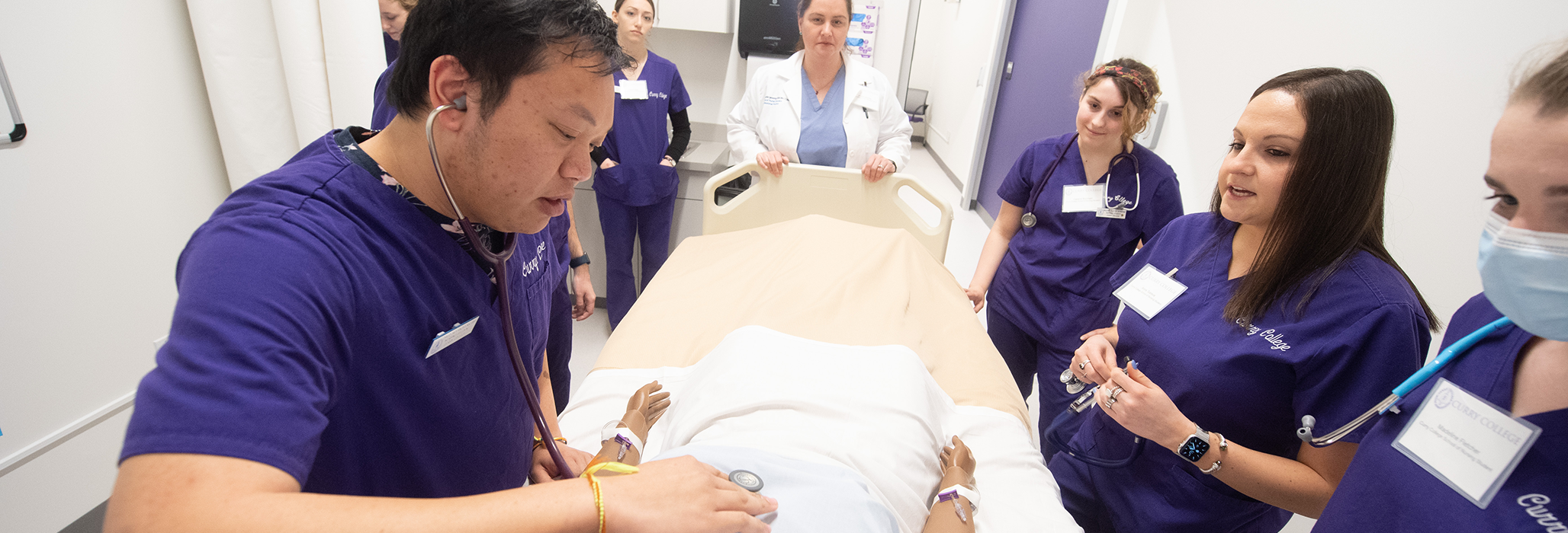 A group of Curry College MSN Students in the nursing labs