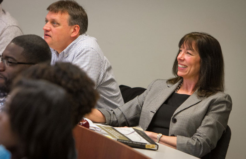 Curry College Master of Science in Accounting student on her laptop smiling