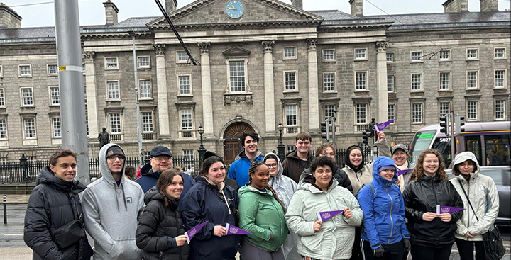 Curry College Study Abroad students pose for a picture in front of an historic building