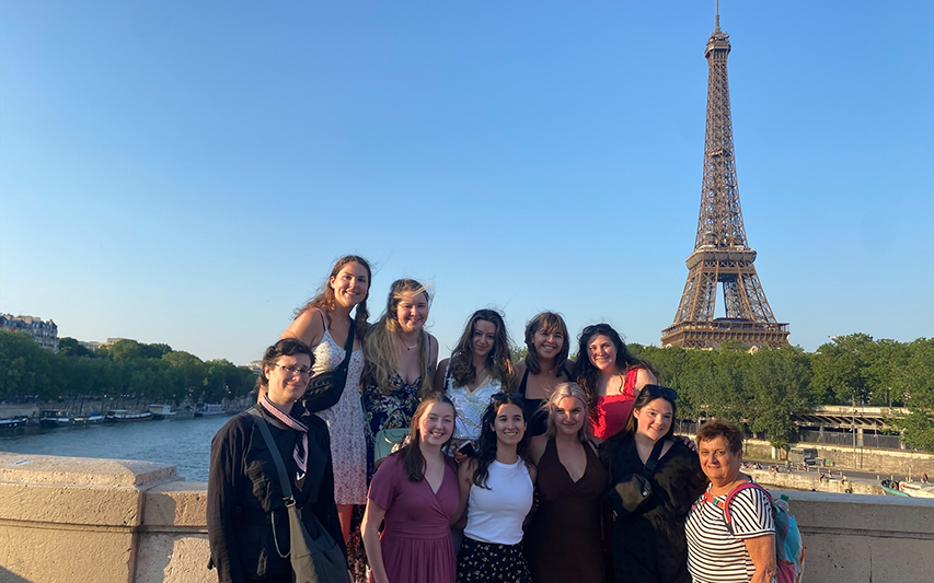 Curry College study abroad students pose for a picture in front of the Eiffel Tower