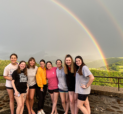 A Curry College Study Abroad student pets an elephant in Thailand