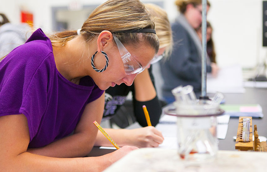 Student in the Chemistry lab at Curry College pursuing a Chemistry minor
