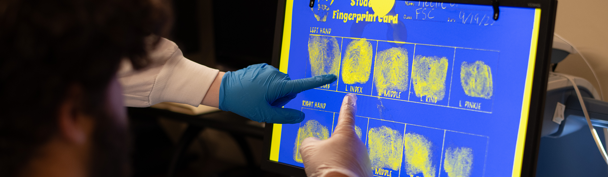 Students review fingerprints in the forensic science lab
