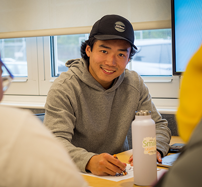 A Curry College faculty member interacts with students in the classroom