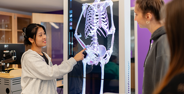 A student interacting with the anatomage table in the Science and Research Center