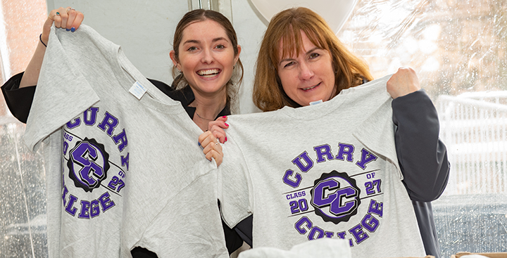 Curry College Admission Counselors hold up class t-shirts