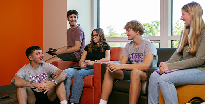 Curry College students hang out in their residence hall common area