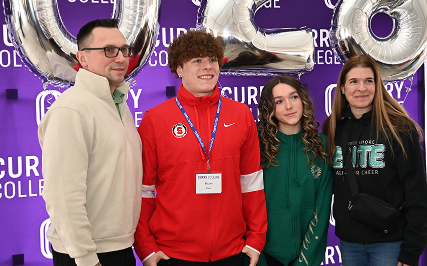 An accepted Curry student and family pose for a photo at Accepted Student Day