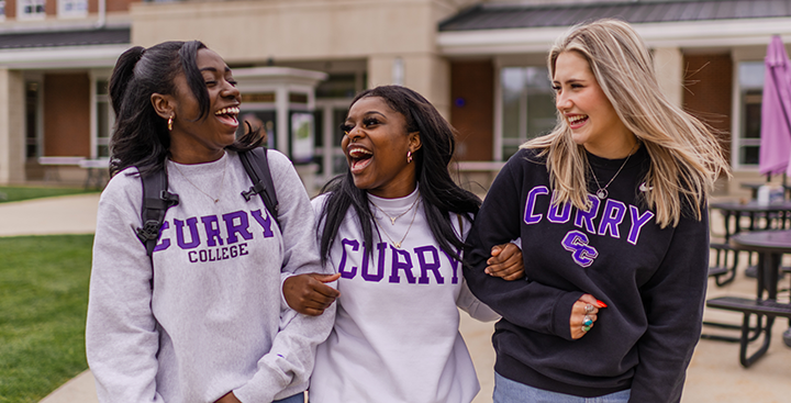 Laughing Curry College students walk to class on campus