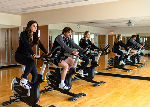 Students work out on the exercise bikes in the Curry College Fitness Center