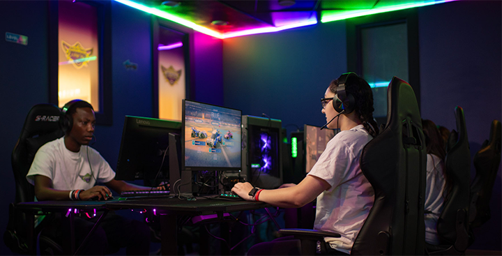 A student playing video games in the Esports Lounge