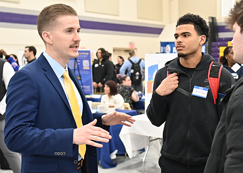 Curry College students network with an employer at the Career Fair on campus