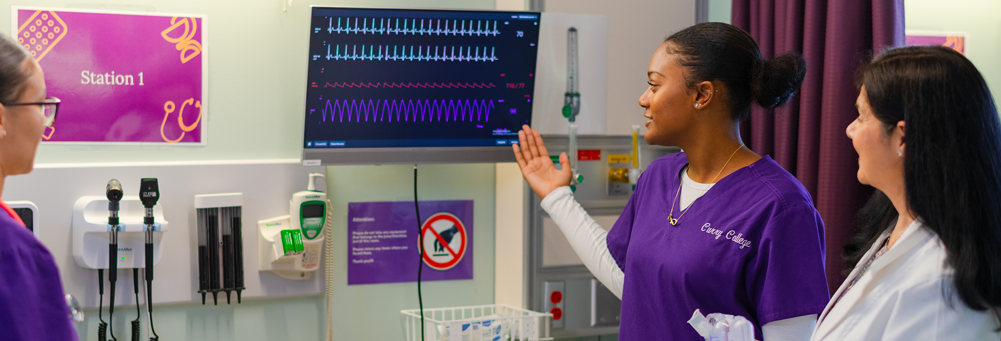 Curry College School of Nursing and Health Sciences student and professor in the simulation lab